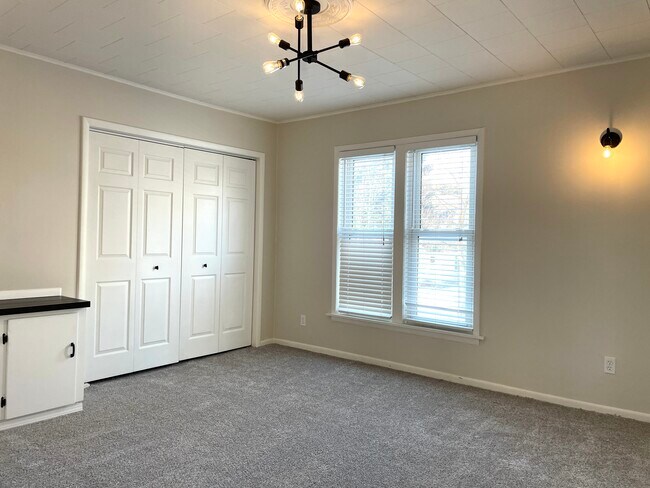 Bedroom has plenty of storage, view of Webster street and dimmable light fixtures. - 432 Webster St