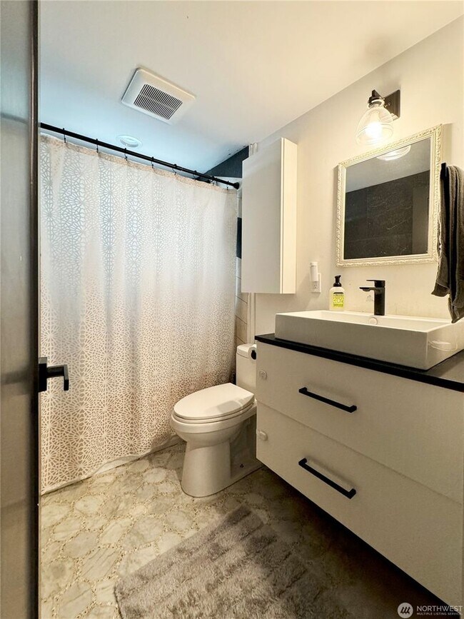 Building Photo - Remodeled 3 bdrm home on a large lot with 500 sq ft wrap around deck!