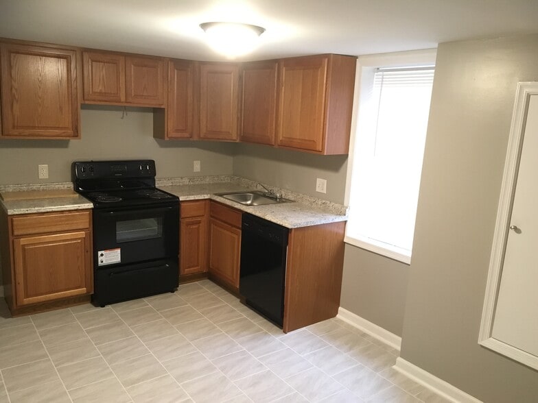 Open concept kitchen w/ dishwasher - Castle Manor Apartments