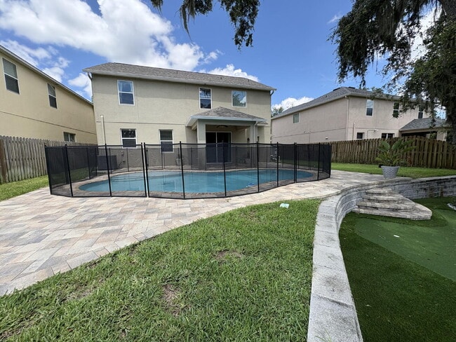 Building Photo - Spacious 5-Bedroom Pool Home with Putting ...