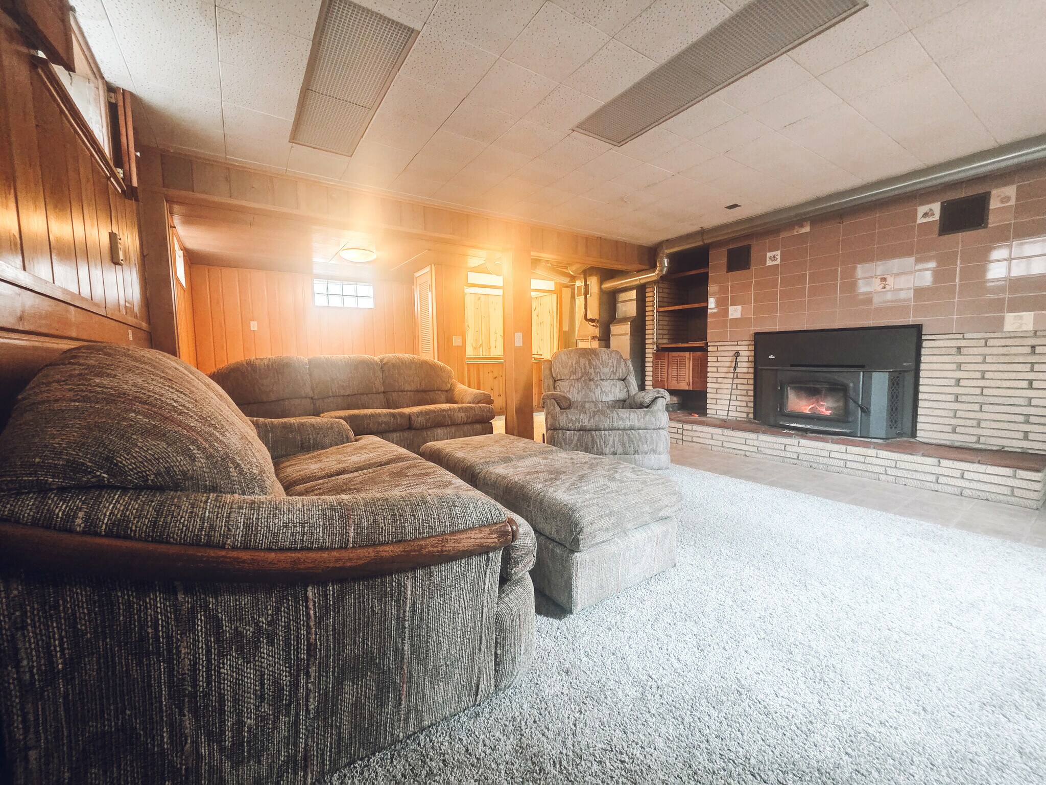 Basement living area with wood burner - 1008 W Singing Woods Rd