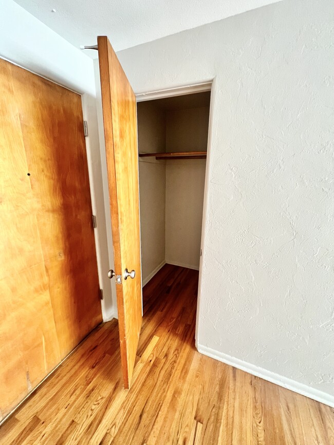 Explore this cozy closet space, perfect for organizing your wardrobe. - The Birney Apartments