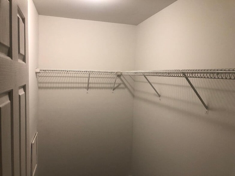 Walk-in closet with built-in wire shelving. - 261 Simpson Ave