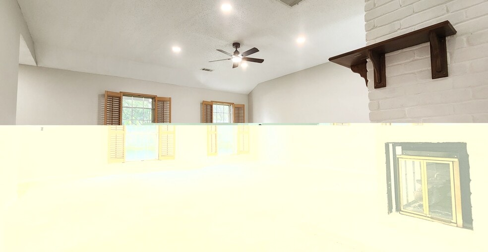 Living room with recessed lighting and a featured white and maple brown fireplace - 4722 Rainbow Run