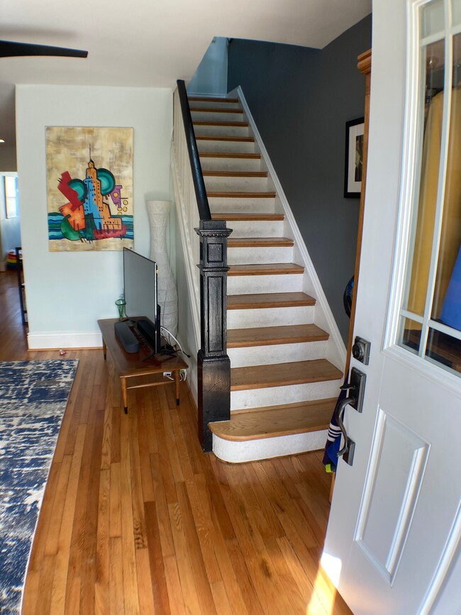 Front door and stairs to upstairs. - 526 24th St NE