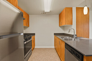 Modern kitchen with tile floors - Avenue Heights Apartments Building 1