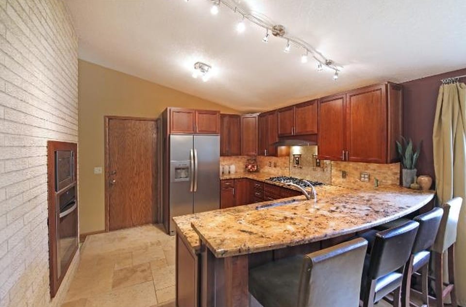 Kitchen with granite counters and stainless steel appliances - 5813 Tracy Avenue