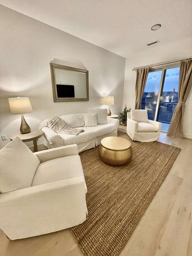 View into the living room. The chairs and sofa are very comfortable for reading, napping, enjoying. - 2530 Lawrence St