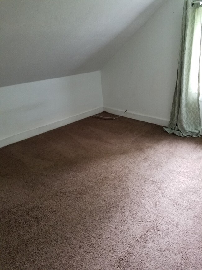 Upstairs Bedroom #1, south wall. Wall to wall carpeting, one window. - 15 Goodrich St