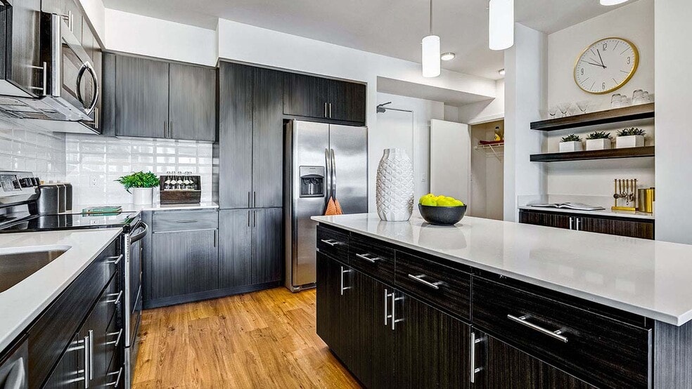 Griffis Shoreline apartment kitchen with quartz countertops. - Griffis Shoreline