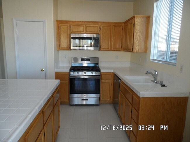 Building Photo - 4 Bedrooms, 2 Bathrooms, 3 Car Garage, 1899 sq. ft., Large Fenced, Front Yard Lawn, Near Schools ...