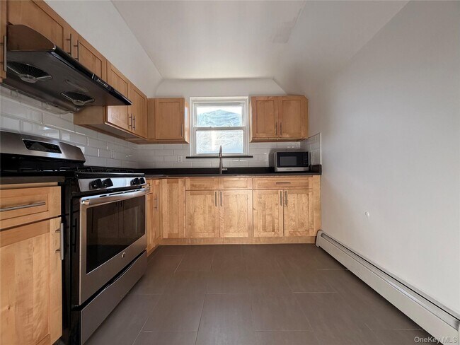 Building Photo - 210-10 56th Ave