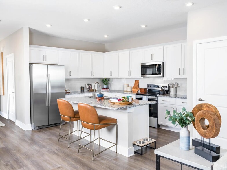 Gourmet kitchens with granite countertops offer a stylish and functional space for cooking and entertaining. Amenity image tile: Gourmet kitchens with quartz countertops - Amavi Kissimmee