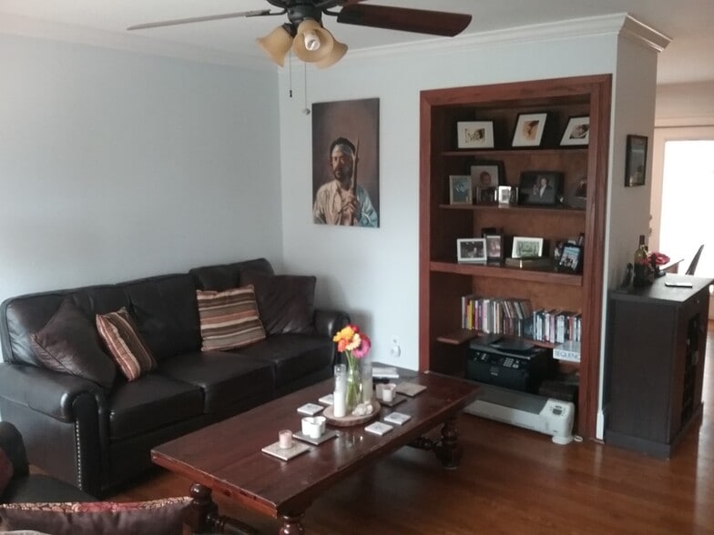 spacious living room with built-in storage and great lighting from large windows - 701 Rosalyn Dr