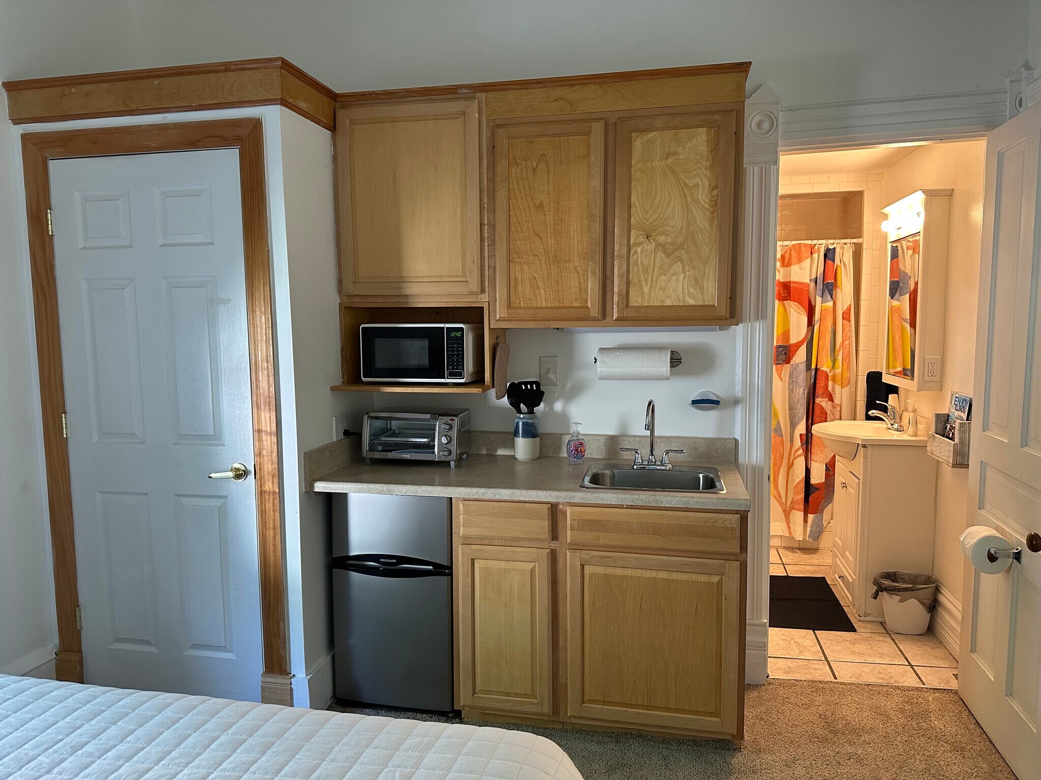 Kitchenette w/ small fridge, toaster, microwave, hotplate. Closet on left, bathroom on right - 305 S Elm St