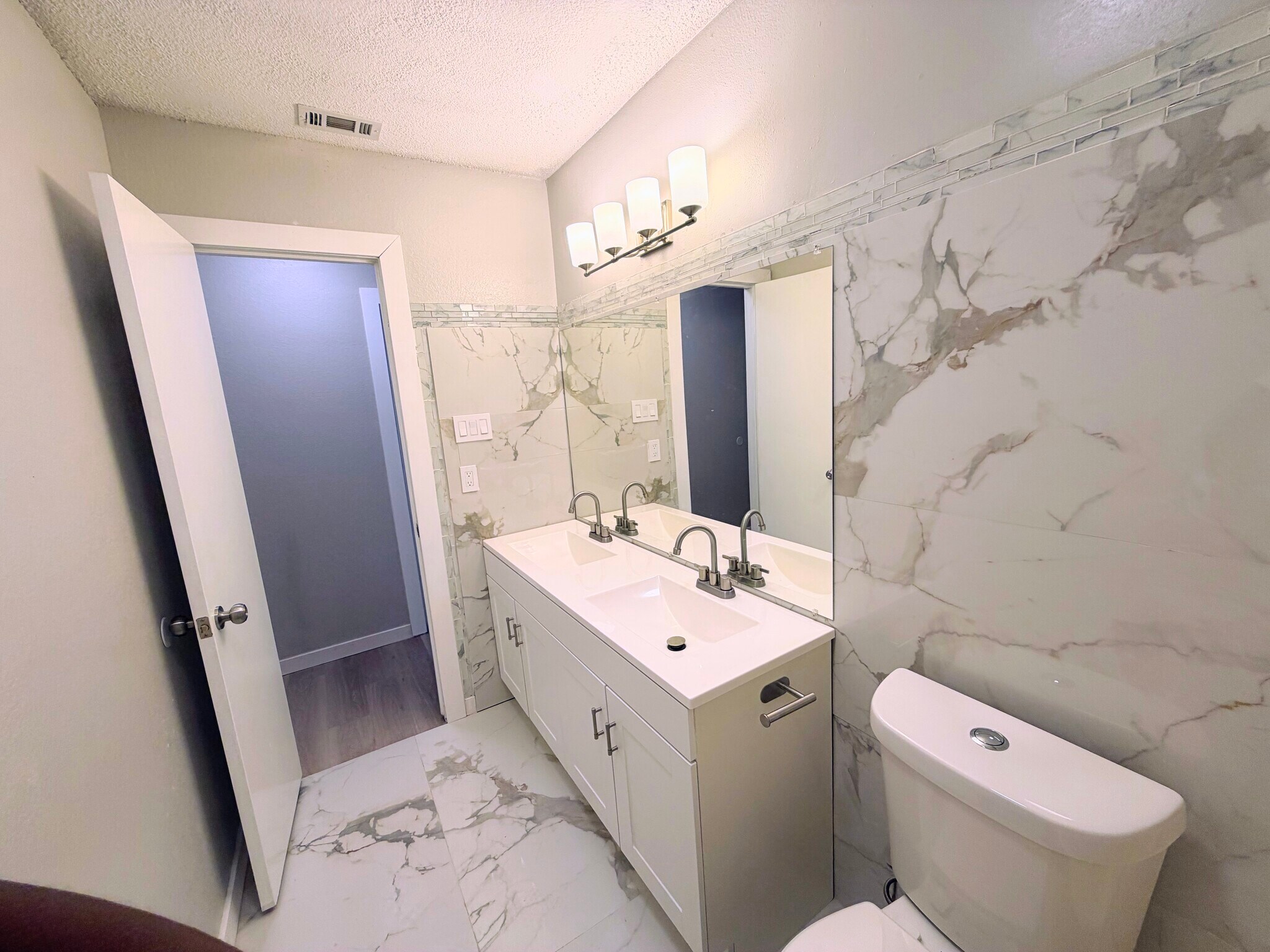 Marble tile bathroom with double vanity - 7501 April Ln
