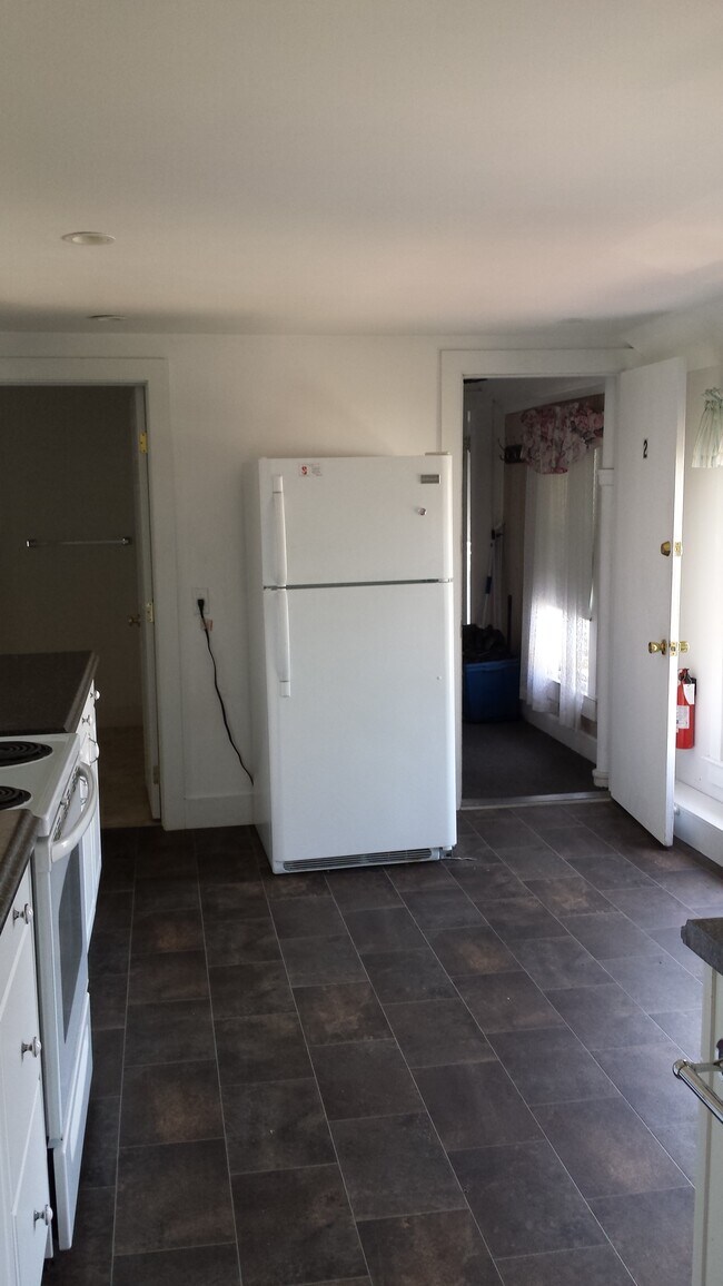 Kitchen to bathroom (L) and front entrance (R) - 50 Douglass St