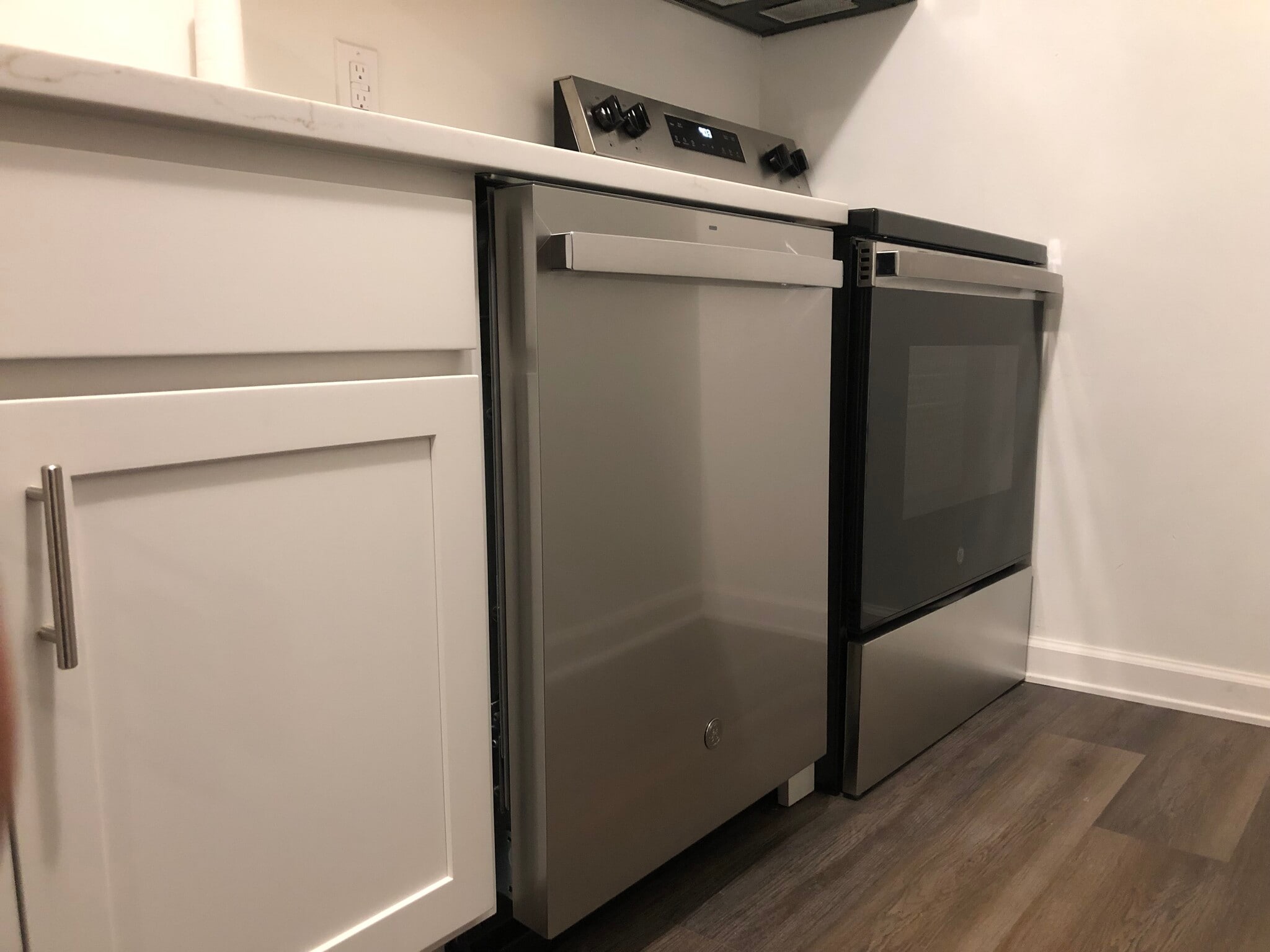 Modern range and dishwasher in updated kitchen. - 261 Simpson Ave