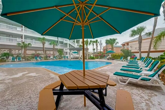 Both pools have tables, chairs, umbrellas & sun loungers - 6102 Seawall Blvd