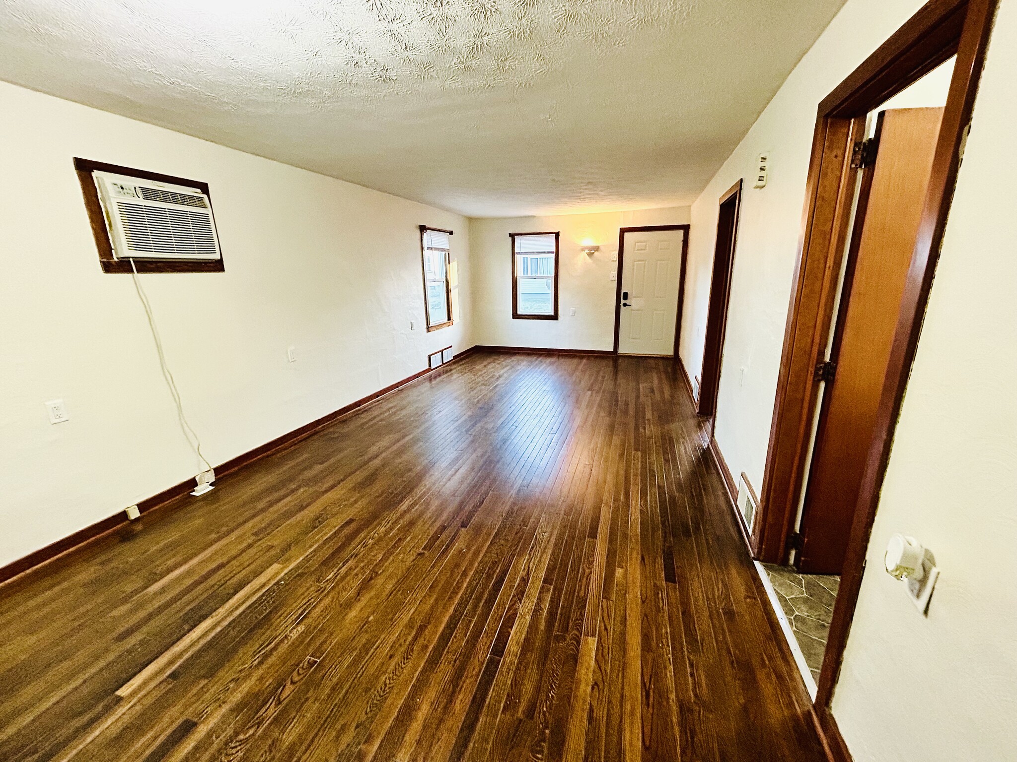 Living room and dining room with hardwood floors - 715 Koogler St