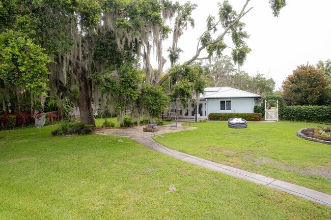 Building Photo - Lake Jessamine Luxury: Solar-Powered Waterfront Retreat on 1.14 Acres with Dock & Boathouse