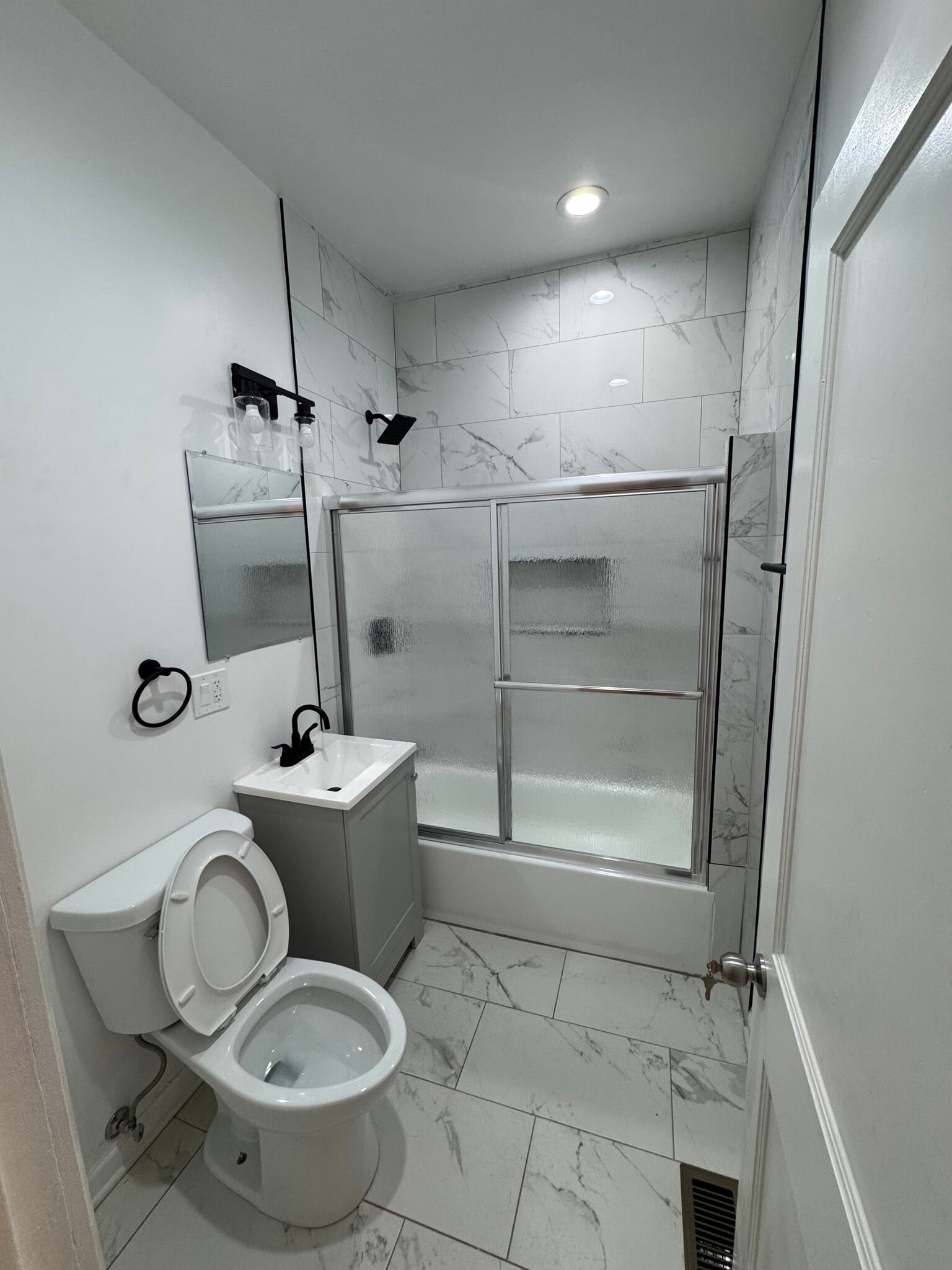Brand new shower with newly installed shower door. - 5432 W 23rd St