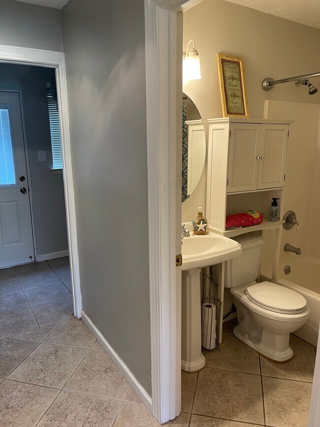 Downstairs full bath off kitchen, laundry room behind and 2nd door to backyard. - 2931 Valley Rose Dr