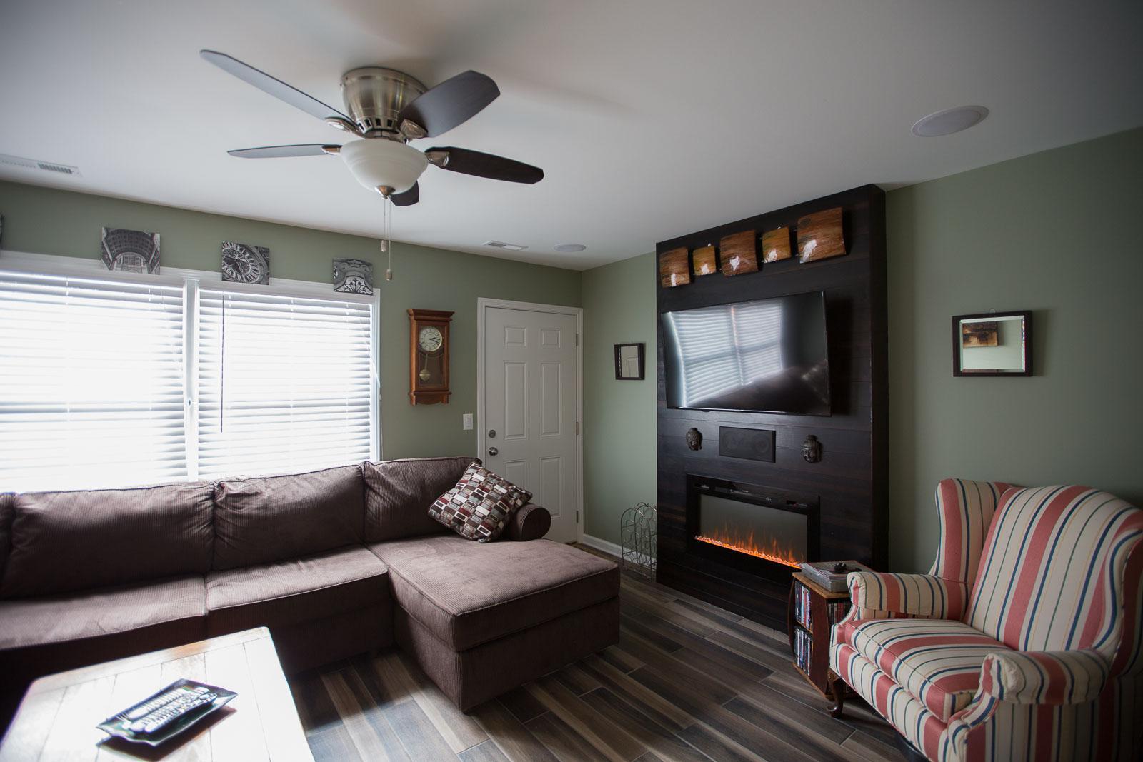Living room with feature wall and fireplace. - 3000 Golden Rd