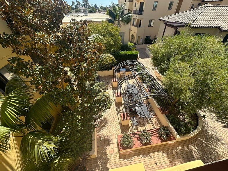 View from front door down into quiet, seclued, courtyard area with BBQ and gazebo. - 130 N Garden St