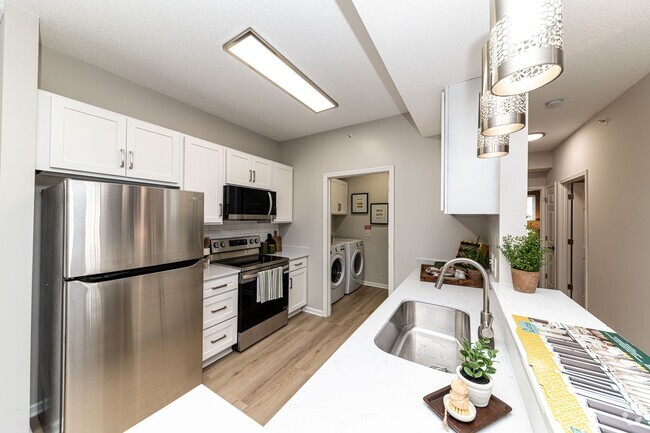 Kitchen with quartz counters, modern cabinetry, & stainless appliances