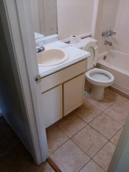 Refaced bathroom cabinets. new ceramic flooring to keep floors safe as you exit the tub or show - 120 Lazy Ln