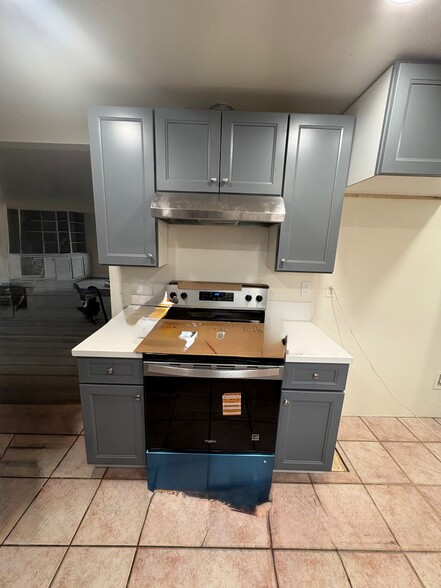 New stove, oven, cabinets and counters next to refrigerator area - 23162 Smith Rd