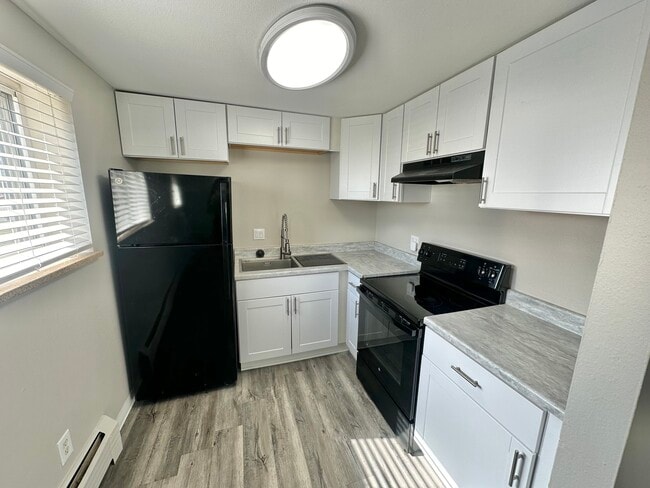 Experience culinary bliss in this contemporary kitchen with stylish amenities. - Allison West Apartments