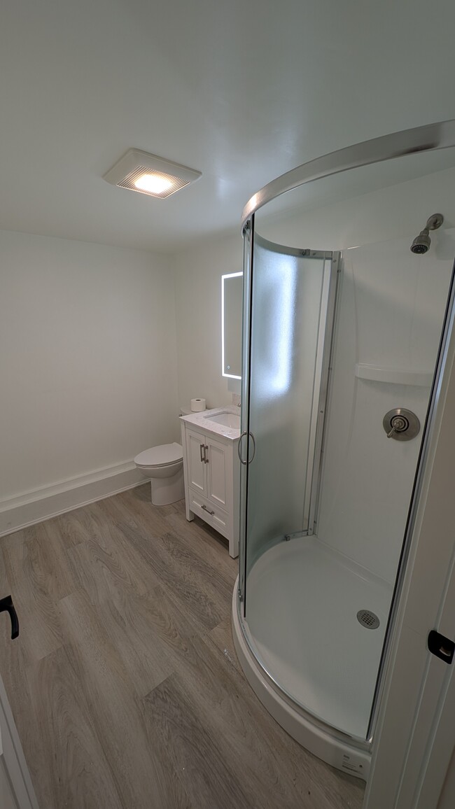 large bathroom with roomy shower and modern vanity lighting - 160 Brackett Hill Rd