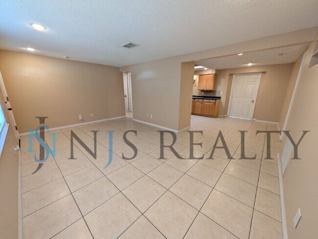 Building Photo - This 3/2/1 with over 1100 sq ft offers all tile floors open kitchen/dining, split floor plan on a...