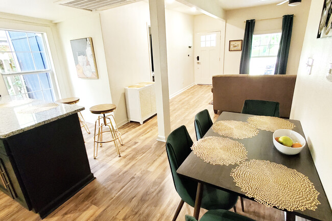 Open floorplan, backside of kitchen bar area + dining table added - 1010 W Chestnut St