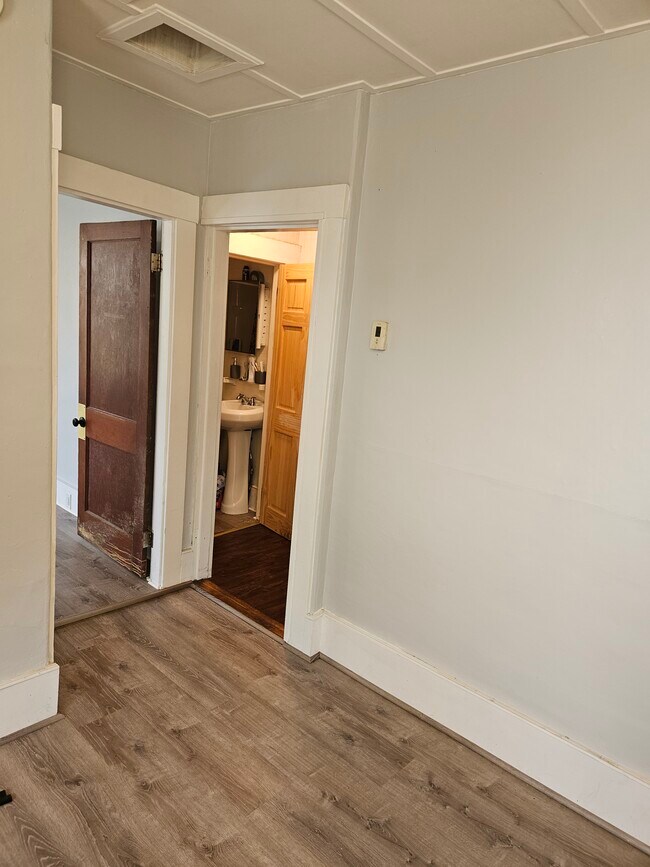 Looking from Dining room to LR on left and downstairs bath with shower on right - 11 Nichols Ave