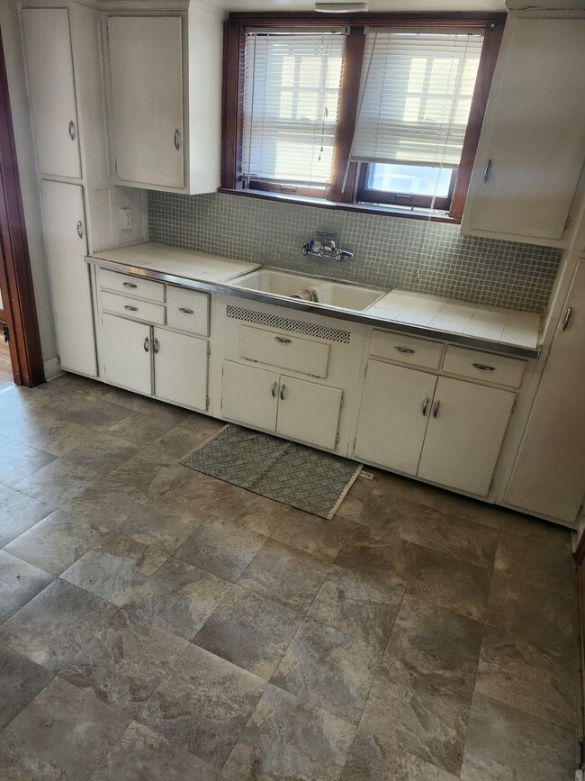 New tile floor in kitchen with lots of cabinets - 4249 Hohman Ave