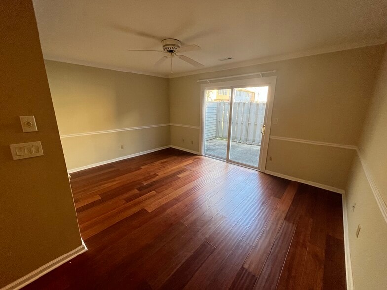 Living room with premium hardwood floors and sliding door to nice outdoor patio - 830 44th Ave N