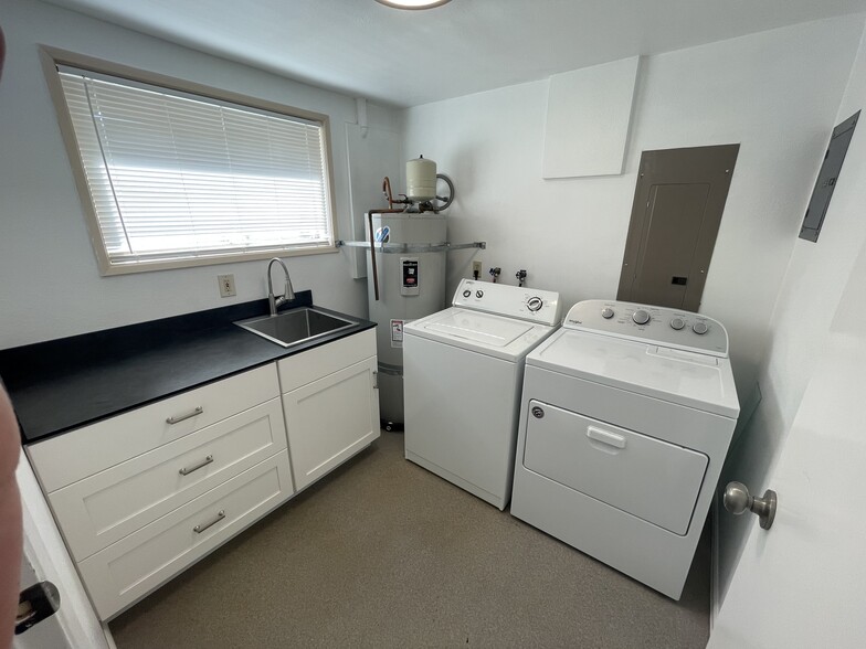 Laundry room with washer,, dryer, utility sink and storage - 22908 54th Ave W
