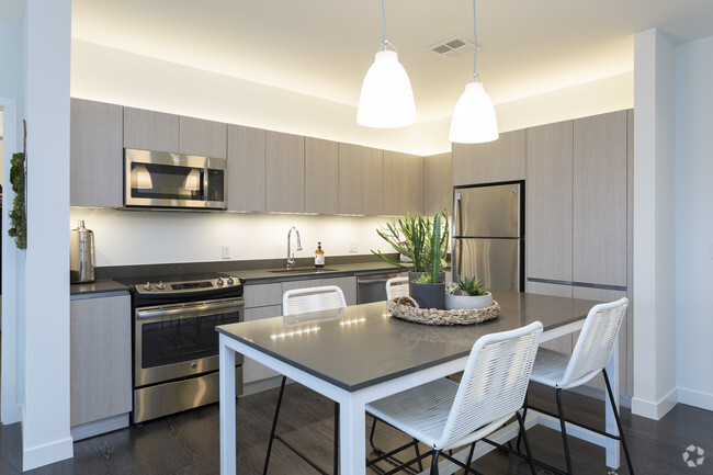 Modern, sleek kitchens feature above and under-cabinet lighting, stainless steel appliances, large s - Woodside Village North