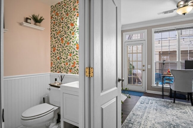 Building Photo - This inviting two-level townhome offers comfort and style, featuring gleaming hardwood floors on ...