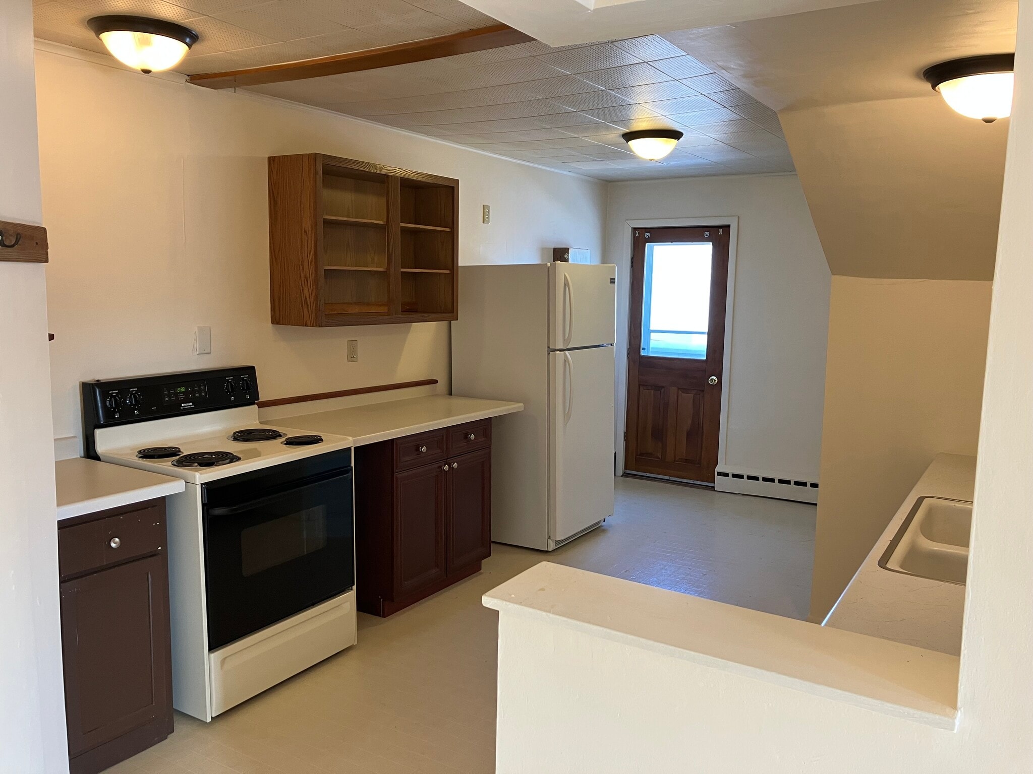 Kitchen, door to balcony, Studio Main #2 - W4160 Main Rd
