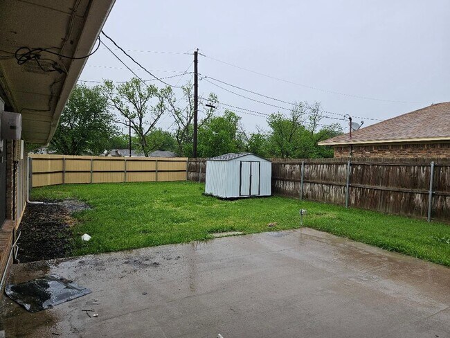 Building Photo - Three bedroom and two bathroom nicely remodeled with new flooring. Large wood fenced backyard