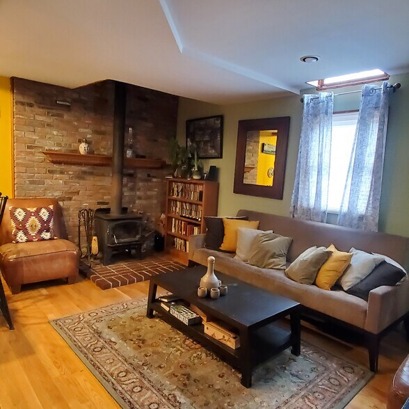 Living room with woodstove - 191 Elliot St