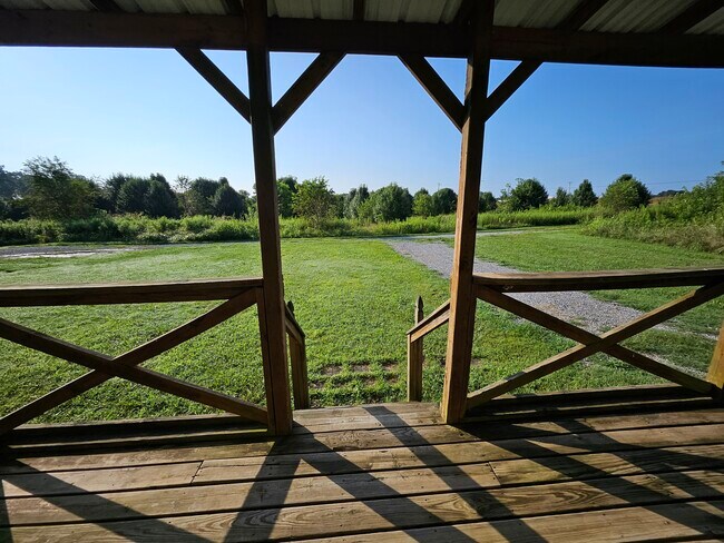 Relax on the covered front porch and enjoy the peace of country living about 5 miles from town. - 5857 Highway 161