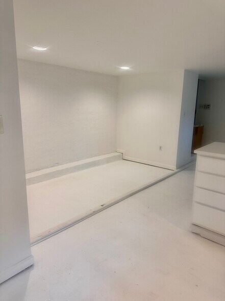 white concrete floors, recessed lighting, all white creates modern feel - 2735 Ontario Rd NW