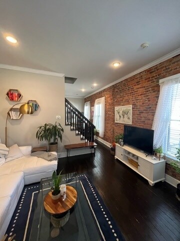 Exposed brick and original hardwood floors. - 713 S 5th St