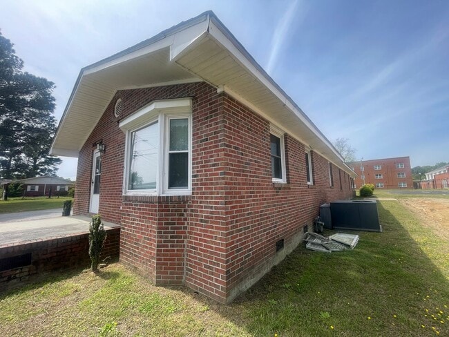 Building Photo - Brick Ranch- Dunn- 4 bedroom 2.5 bath- 2 car carport- Corner Lot