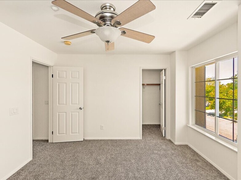 bedroom 1 upstairs with a walk-in closet - 1586 Silver Cup Ct